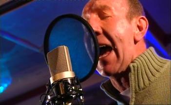 [den singing]